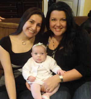 Veronica Reno and Dixie Kugler holding a child